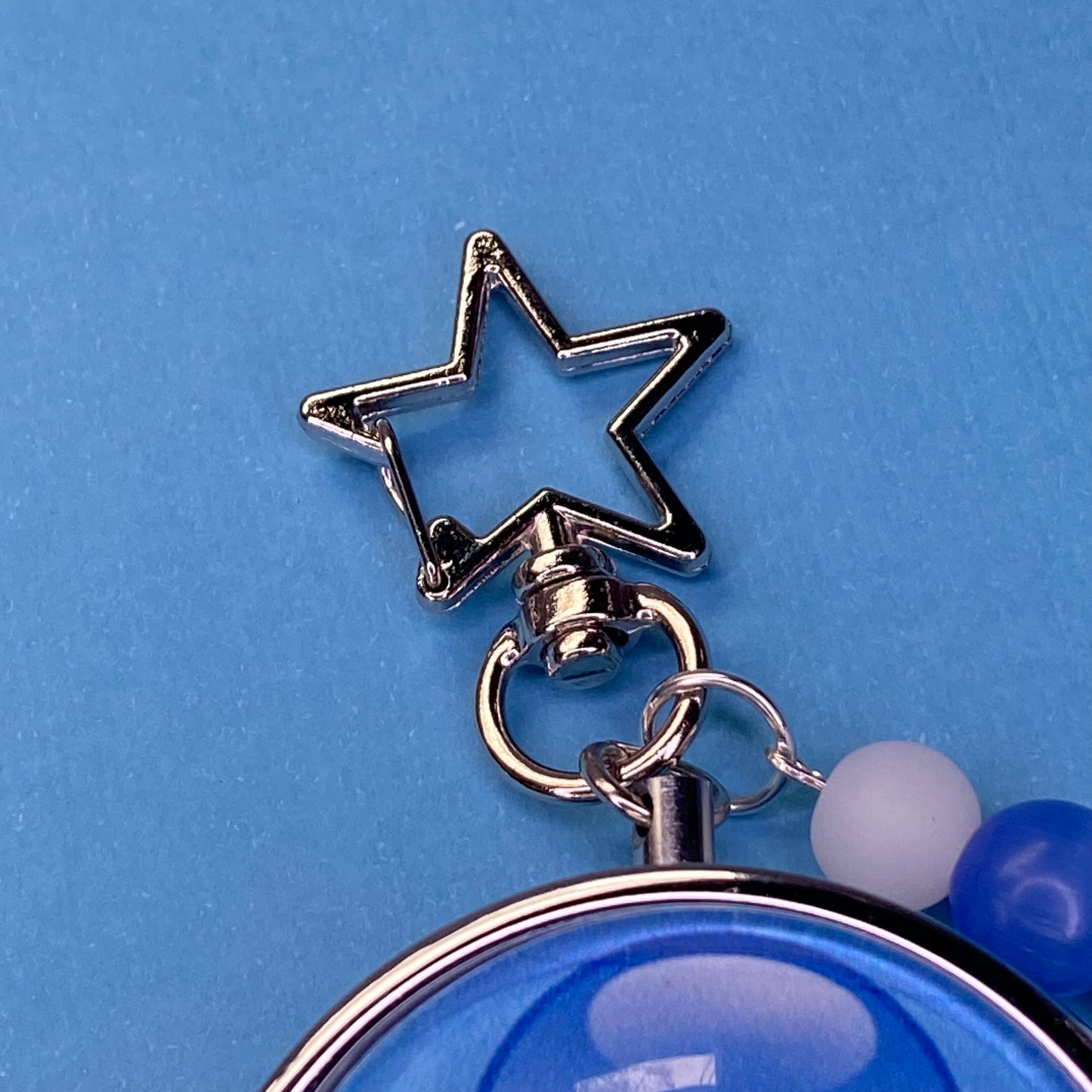 Blue Frutiger aero icon keychain pill case