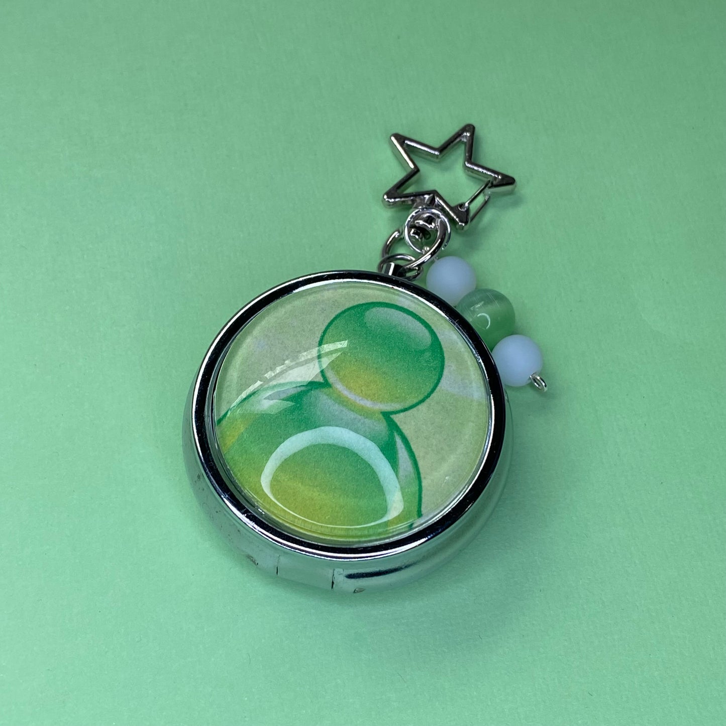 Green Frutiger aero icon keychain pill case