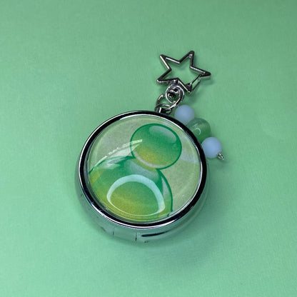 Green Frutiger aero icon keychain pill case