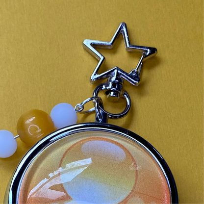 Yellow Frutiger aero icon keychain pill case