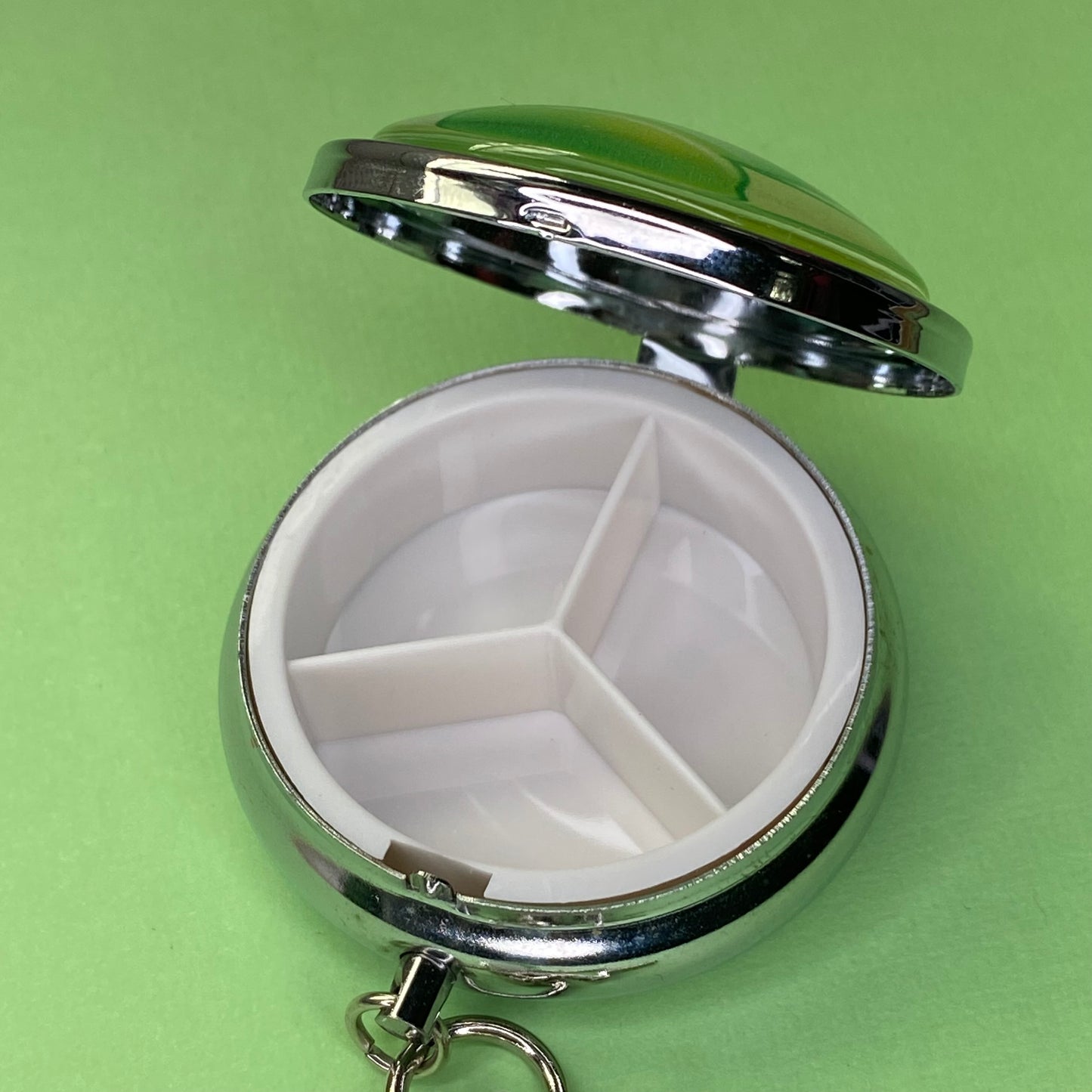 Green Frutiger aero icon keychain pill case