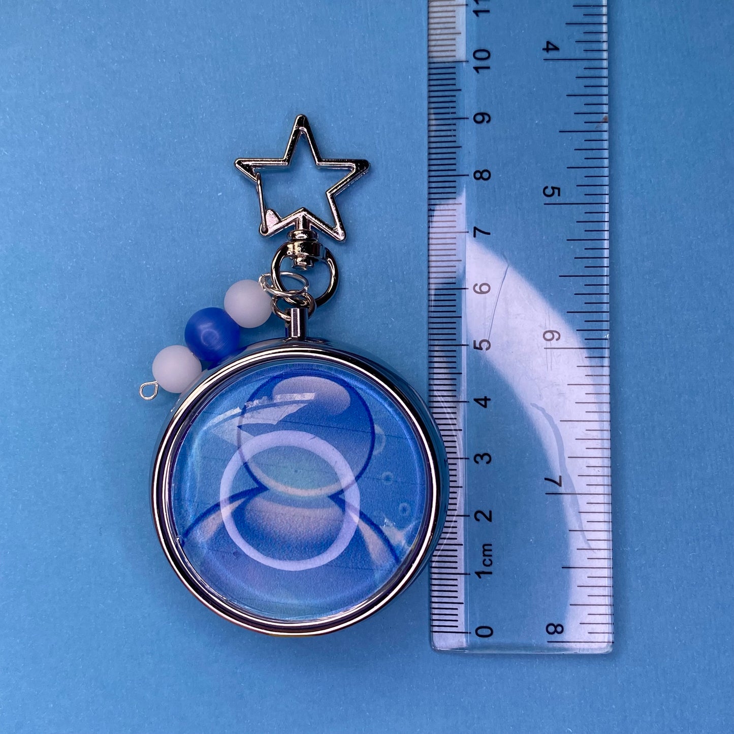 Blue Frutiger aero icon keychain pill case