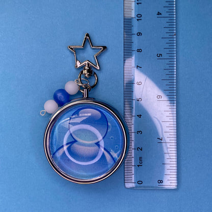 Blue Frutiger aero icon keychain pill case
