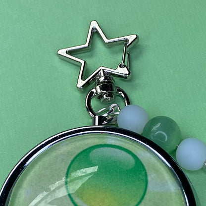Green Frutiger aero icon keychain pill case