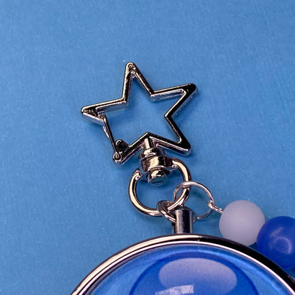 Blue Frutiger aero icon keychain pill case