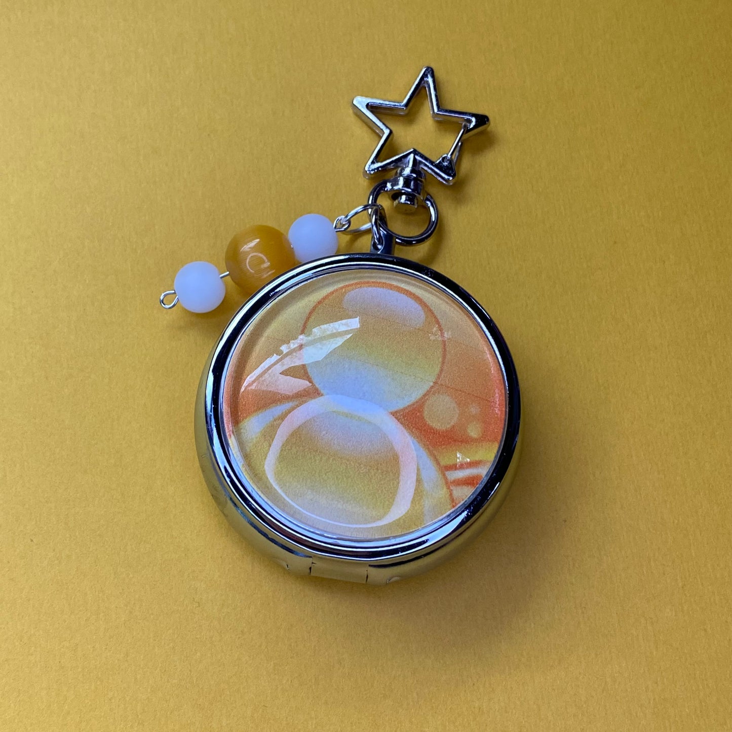 Yellow Frutiger aero icon keychain pill case