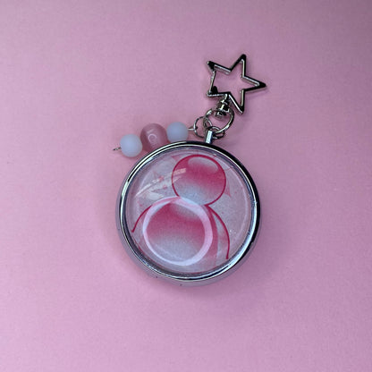 Pink Frutiger aero icon keychain pill case