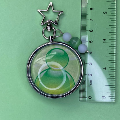 Green Frutiger aero icon keychain pill case