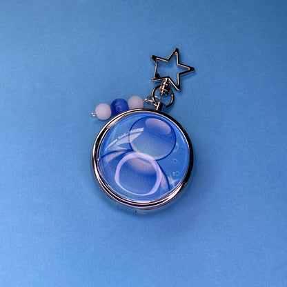 Blue Frutiger aero icon keychain pill case