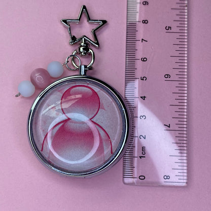Pink Frutiger aero icon keychain pill case