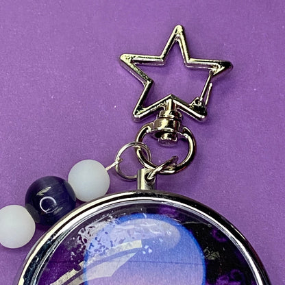 Purple Frutiger aero icon keychain pill case
